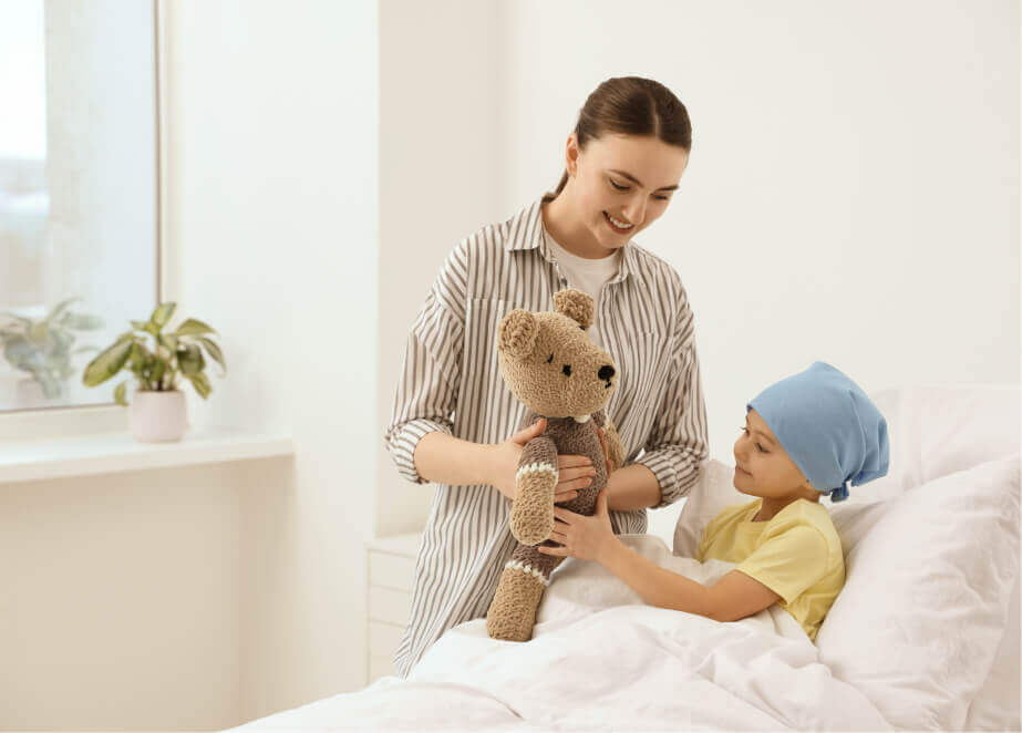 woman holding a teddy bear next to a little boy