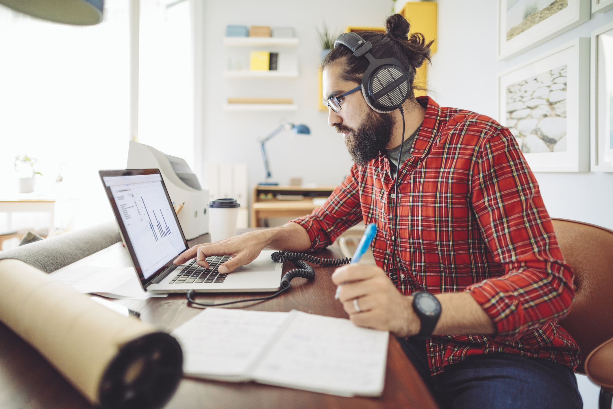 Young professional working on a real estate deal in his home office.